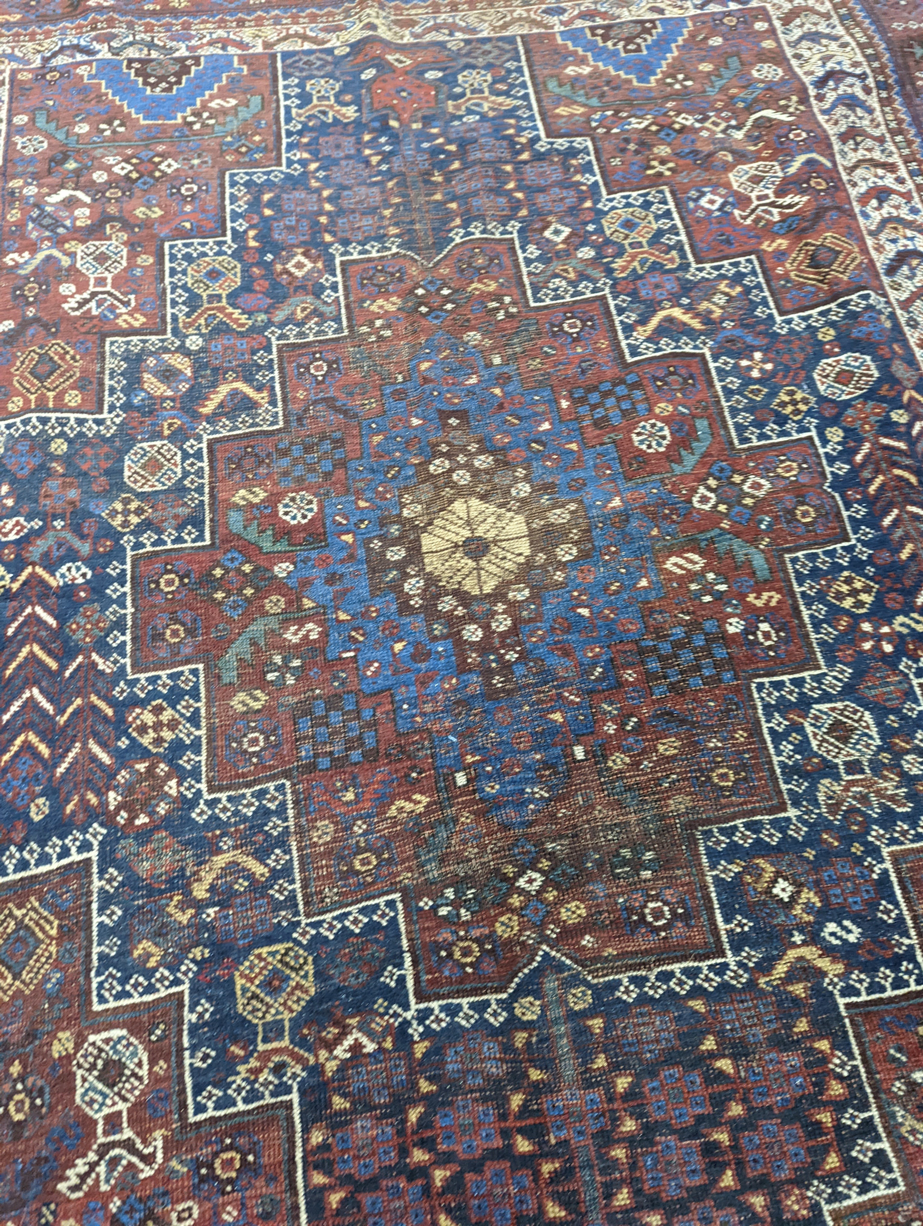 A Caucasian red ground rug and a Belouch rug, larger 200 x 165cm